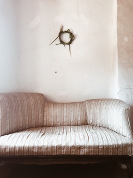 antique sofa with green wreath
