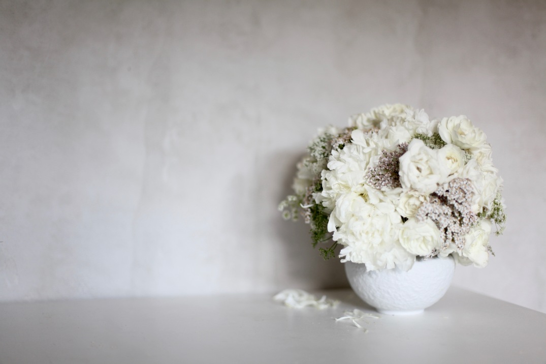 white floral arrangement, concrete walls 